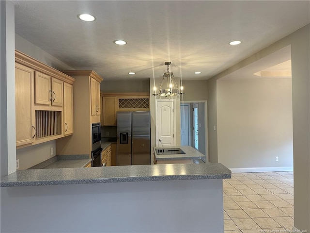 kitchen with light brown cabinetry, stainless steel fridge, kitchen peninsula, and black oven