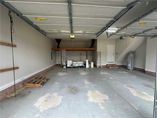 garage with a garage door opener and electric water heater