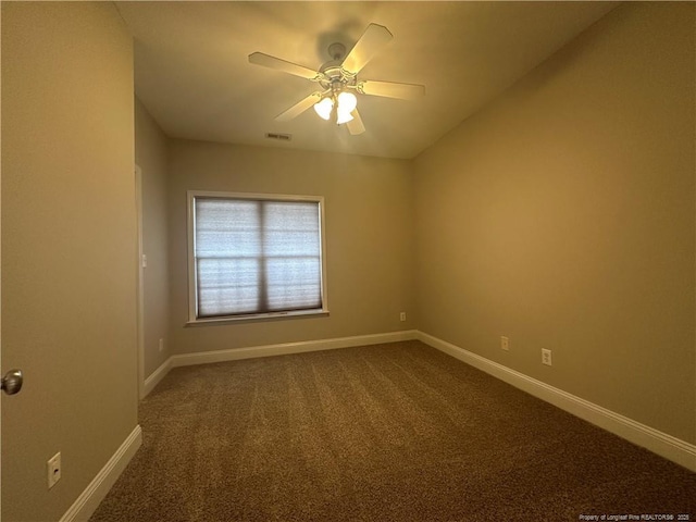 carpeted spare room featuring ceiling fan