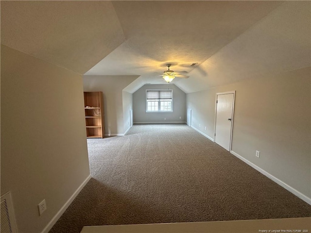 bonus room with lofted ceiling, carpet flooring, and ceiling fan