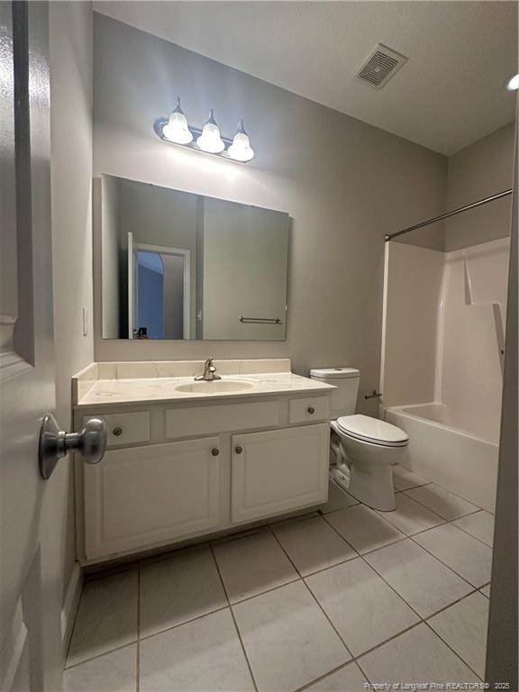 full bathroom with tile patterned flooring, vanity, tub / shower combination, and toilet