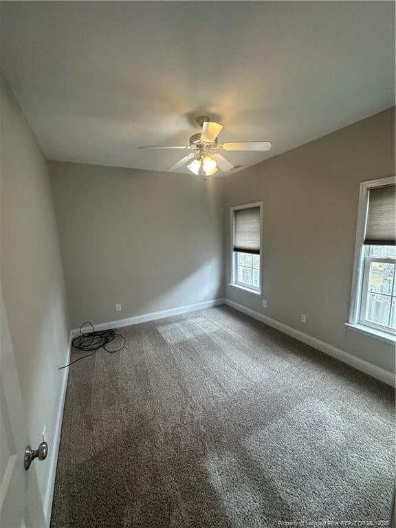 unfurnished room featuring ceiling fan and carpet flooring