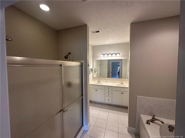 bathroom featuring tile patterned flooring, vanity, and separate shower and tub