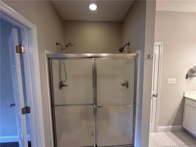 bathroom with vanity, tile patterned floors, and a shower with shower door