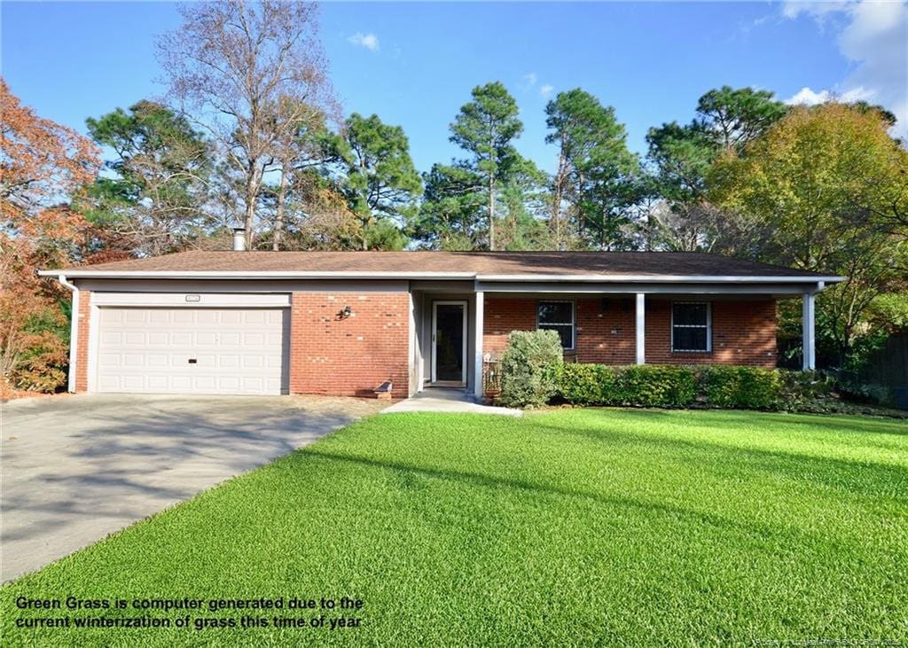 ranch-style home featuring a garage and a front yard