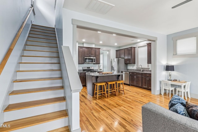 staircase with sink and hardwood / wood-style floors