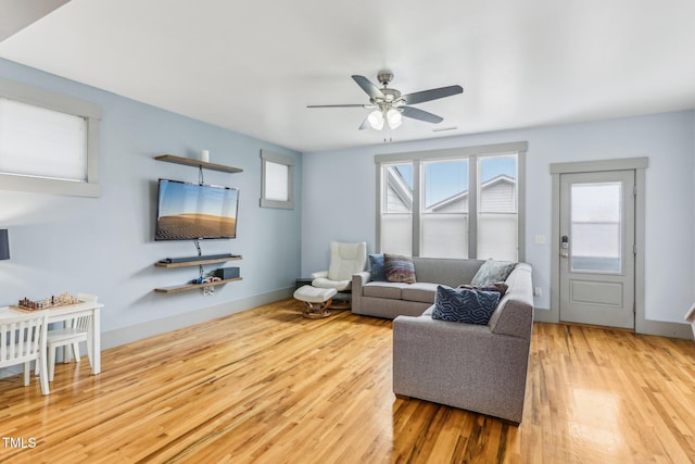 living room featuring hardwood / wood-style flooring and ceiling fan