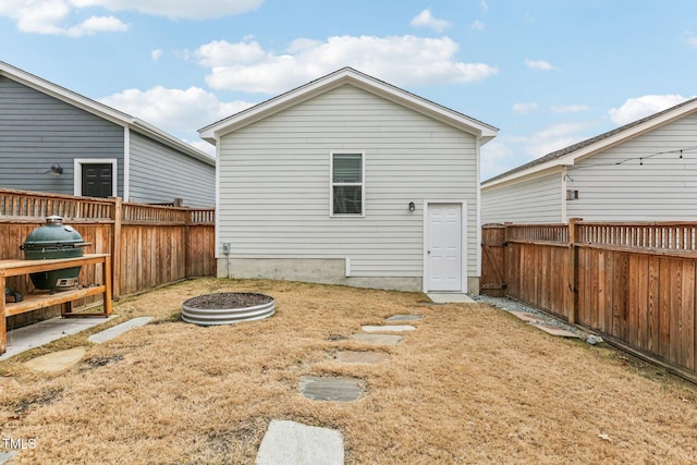 back of house with a lawn