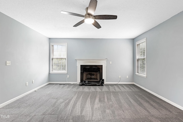 unfurnished living room with carpet, a textured ceiling, and ceiling fan