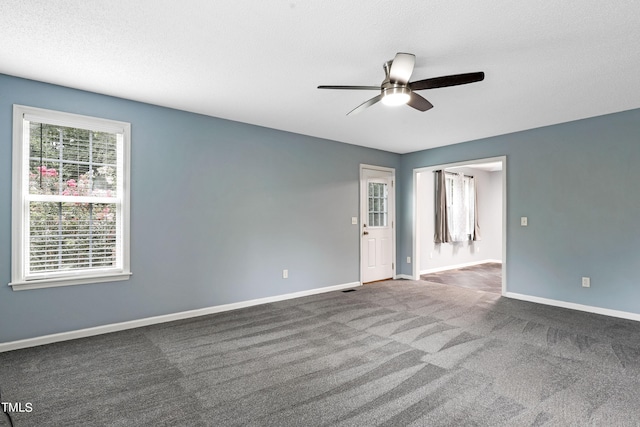 carpeted empty room featuring ceiling fan