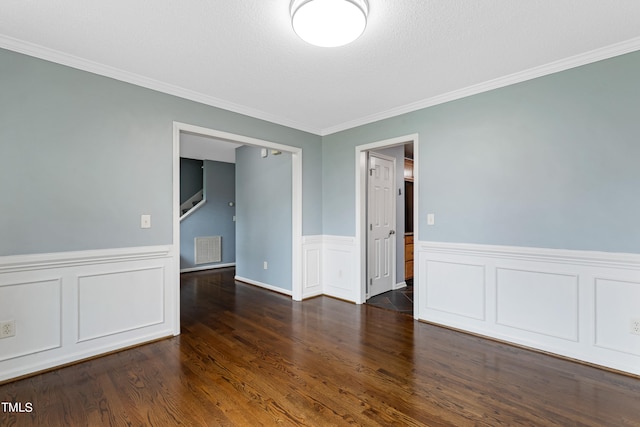 unfurnished room with dark hardwood / wood-style flooring and ornamental molding