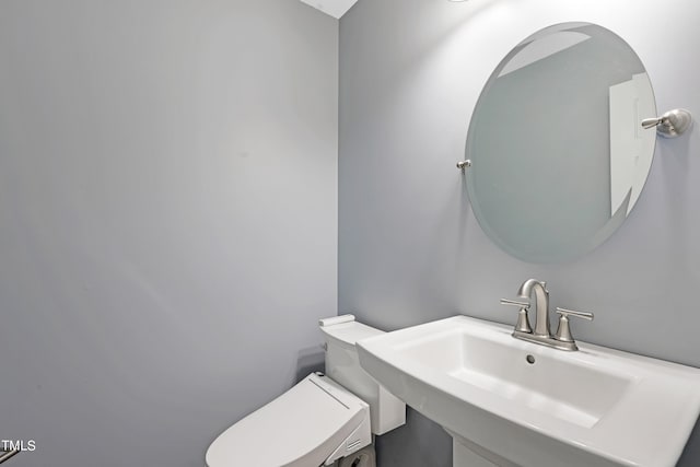 bathroom with toilet and sink