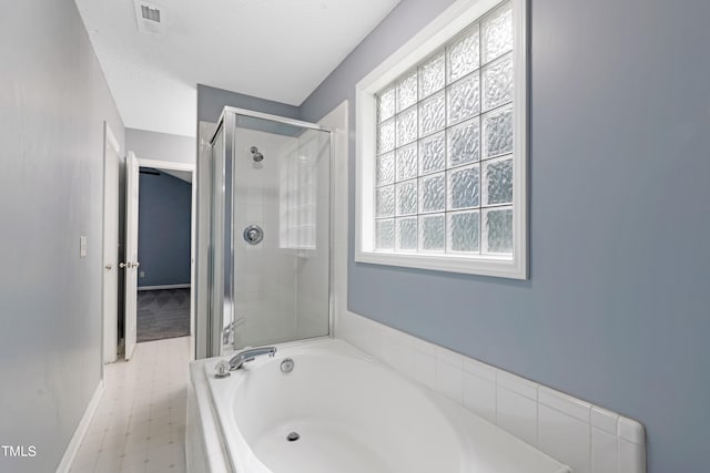 bathroom with separate shower and tub