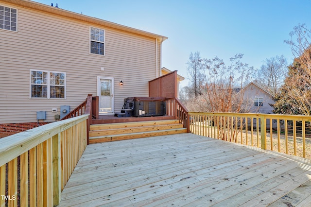 wooden deck featuring a jacuzzi