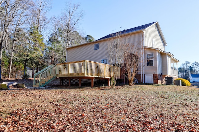 rear view of house with cooling unit and a deck