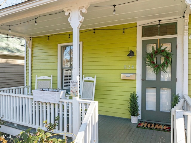 view of exterior entry with covered porch