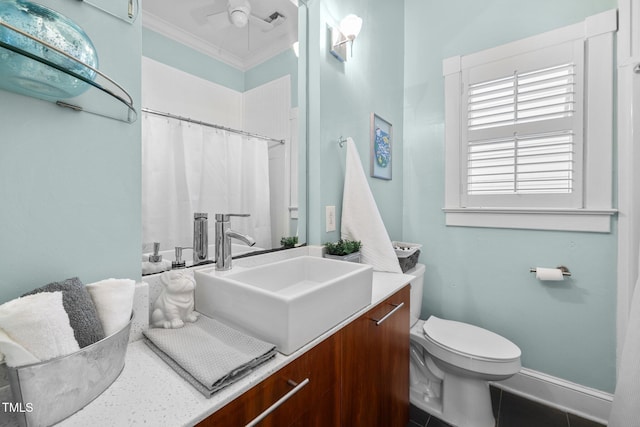 bathroom with ceiling fan, tile patterned floors, toilet, vanity, and ornamental molding