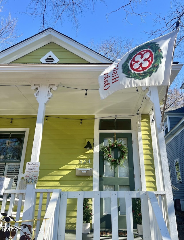 view of exterior entry featuring a porch