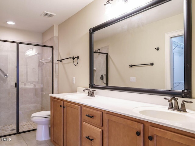 bathroom featuring tile patterned flooring, vanity, and a shower with shower door