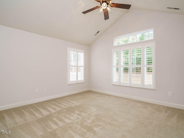 spare room with ceiling fan, light colored carpet, and a healthy amount of sunlight