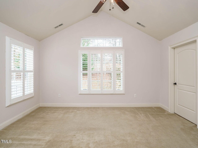 carpeted empty room featuring vaulted ceiling and ceiling fan