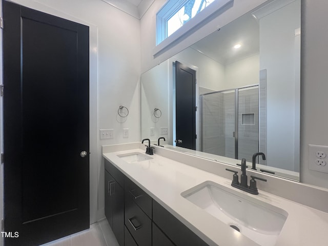 bathroom with tile patterned flooring, a shower with shower door, and vanity