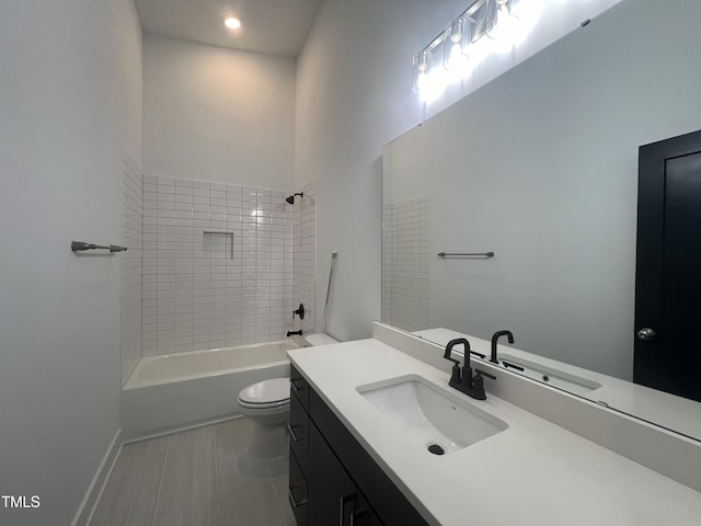 full bathroom with vanity, toilet, and tiled shower / bath