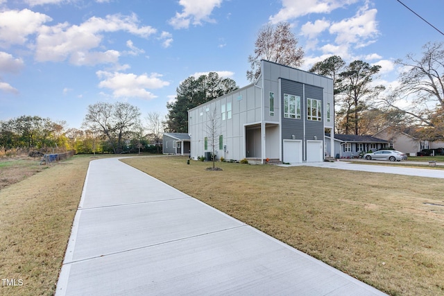 view of home's exterior with a garage and a yard