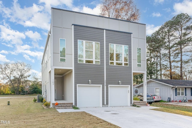 contemporary home with a front yard and a garage