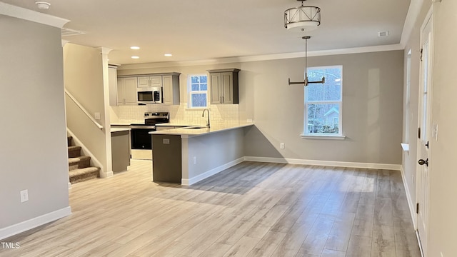 kitchen featuring a wealth of natural light, sink, light hardwood / wood-style flooring, and appliances with stainless steel finishes