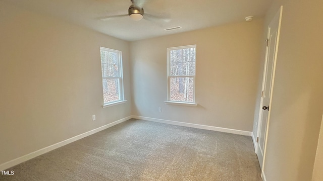 carpeted spare room with ceiling fan