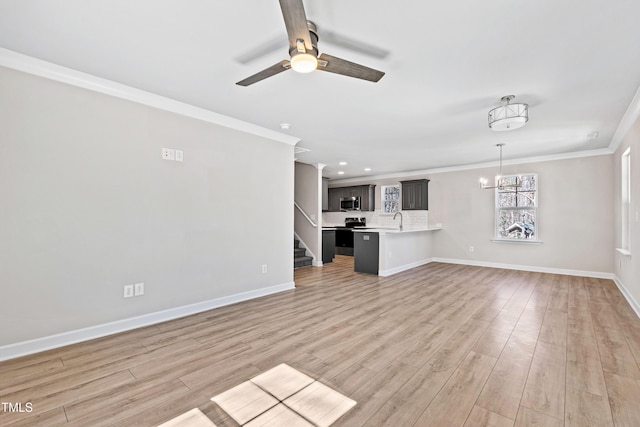 unfurnished living room with ceiling fan with notable chandelier, a sink, baseboards, light wood-style floors, and crown molding