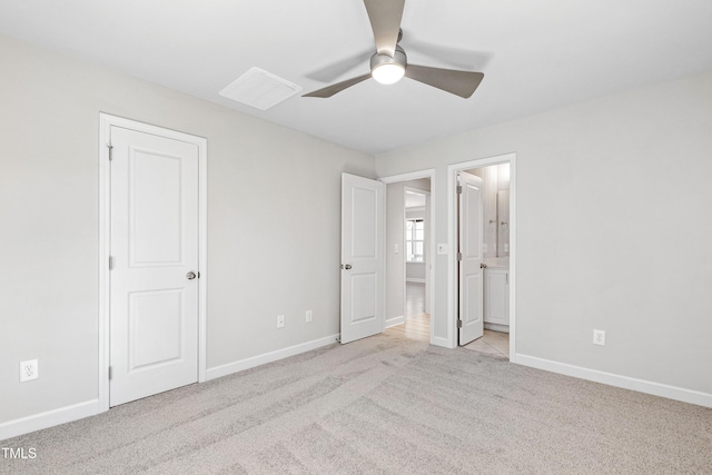 unfurnished bedroom with a ceiling fan, carpet, baseboards, and connected bathroom