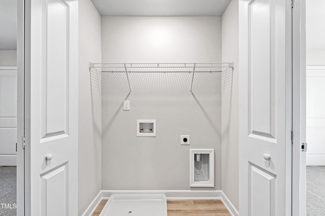 laundry area featuring laundry area, light wood finished floors, baseboards, hookup for an electric dryer, and washer hookup