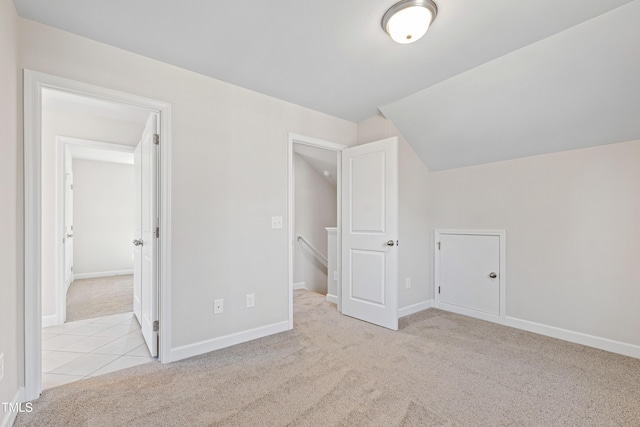 additional living space with lofted ceiling, baseboards, and carpet flooring