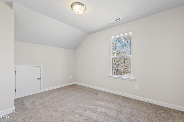 bonus room with lofted ceiling, baseboards, visible vents, and carpet flooring