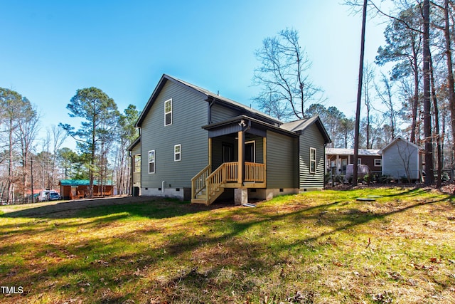 rear view of property with crawl space and a yard