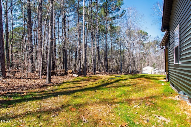 view of yard with a view of trees