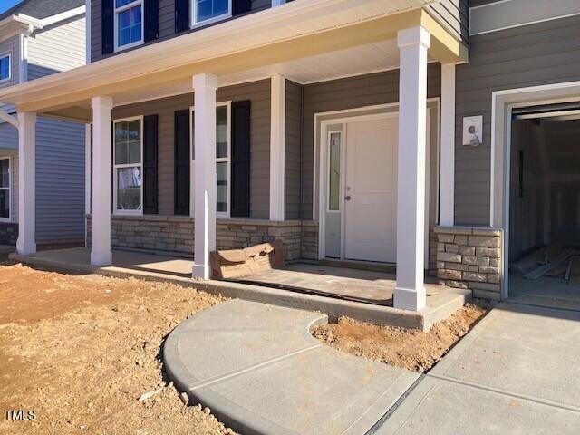 view of exterior entry featuring a porch