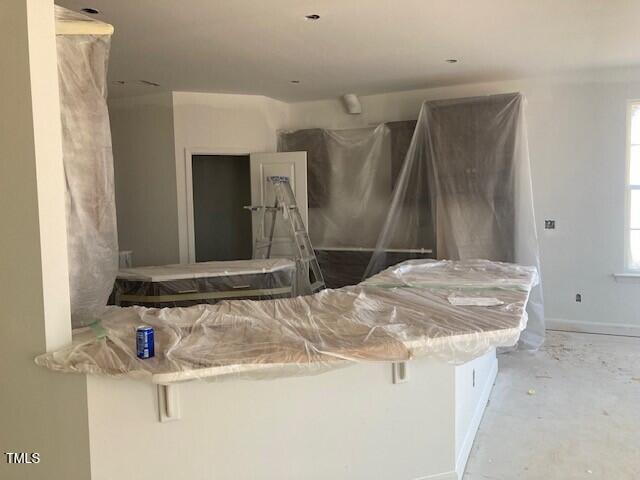 bathroom featuring plenty of natural light and concrete flooring