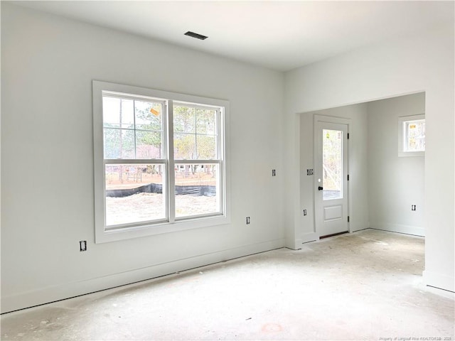 unfurnished room with baseboards