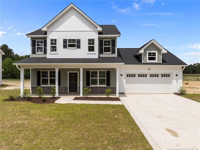 1585 Scull Rd, Raeford, NC 28376 - view of front of home featuring board and batten siding, an attached garage, a front lawn, driveway, and covered porch