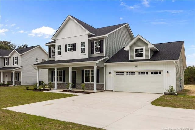 1585 Scull Rd, Raeford, NC 28376 - view of front of home with board and batten siding, concrete driveway, a porch, a front lawn, and stone siding