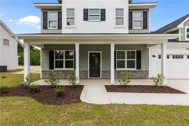 1585 Scull Rd, Raeford, NC 28376 - view of front facade with covered porch, stone siding, an attached garage, cooling unit, and board and batten siding