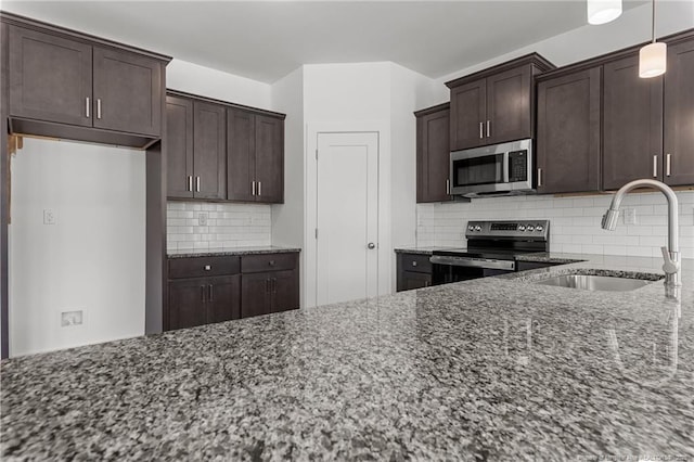 1585 Scull Rd, Raeford, NC 28376 - kitchen featuring stainless steel appliances, a sink, dark stone countertops, decorative backsplash, and dark brown cabinets