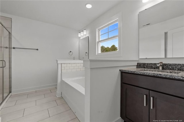 1585 Scull Rd, Raeford, NC 28376 - full bath featuring a stall shower, a garden tub, vanity, tile patterned flooring, and baseboards