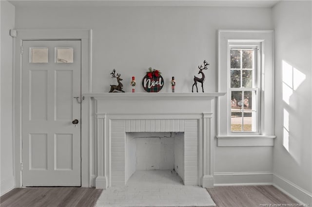 room details with a brick fireplace and hardwood / wood-style flooring