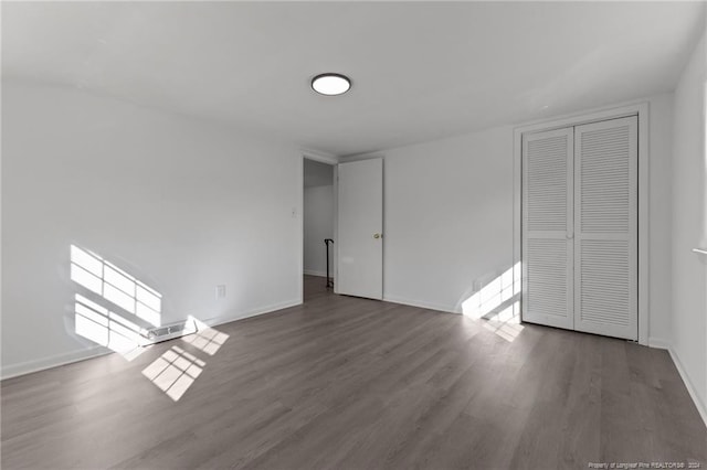 interior space featuring a closet and dark wood-type flooring