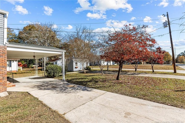 view of yard with a shed and a carport