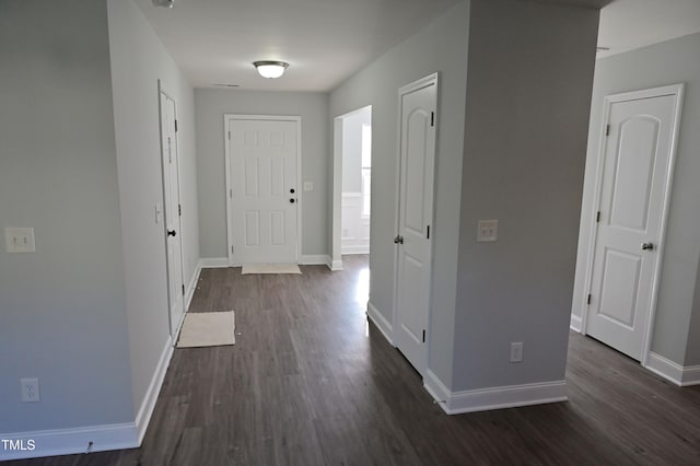 corridor with dark hardwood / wood-style flooring